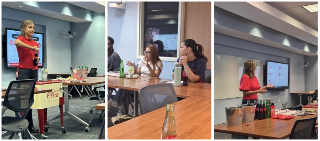 Screenshot - Coca-Cola Beverages Florida Woman in a red polo stands at the front of a meeting room, gesturing while a slide is shown on a screen behind her.
